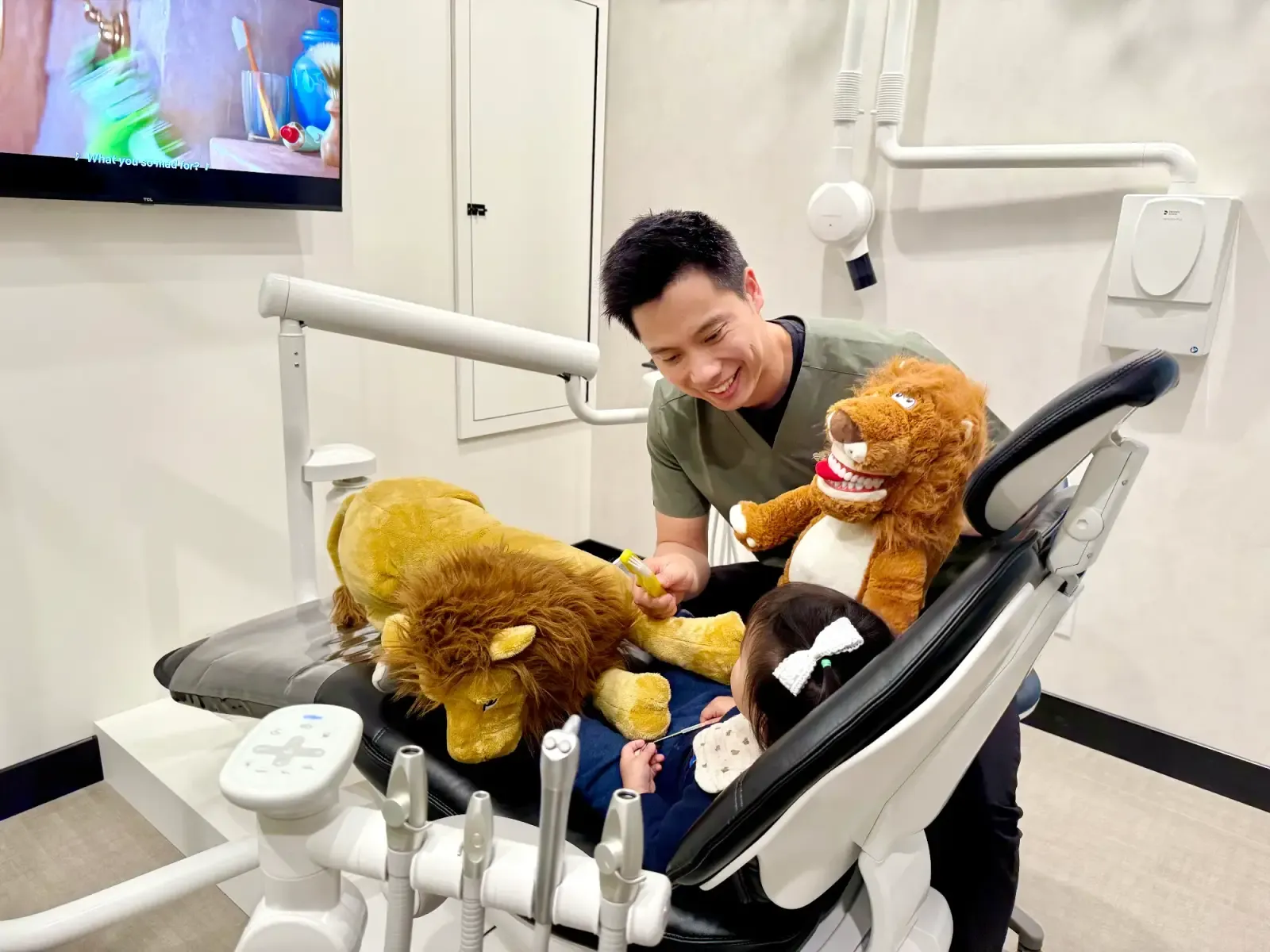 Dr. Brian Hu making a child's dental visit fun at Creekside Dental Langley