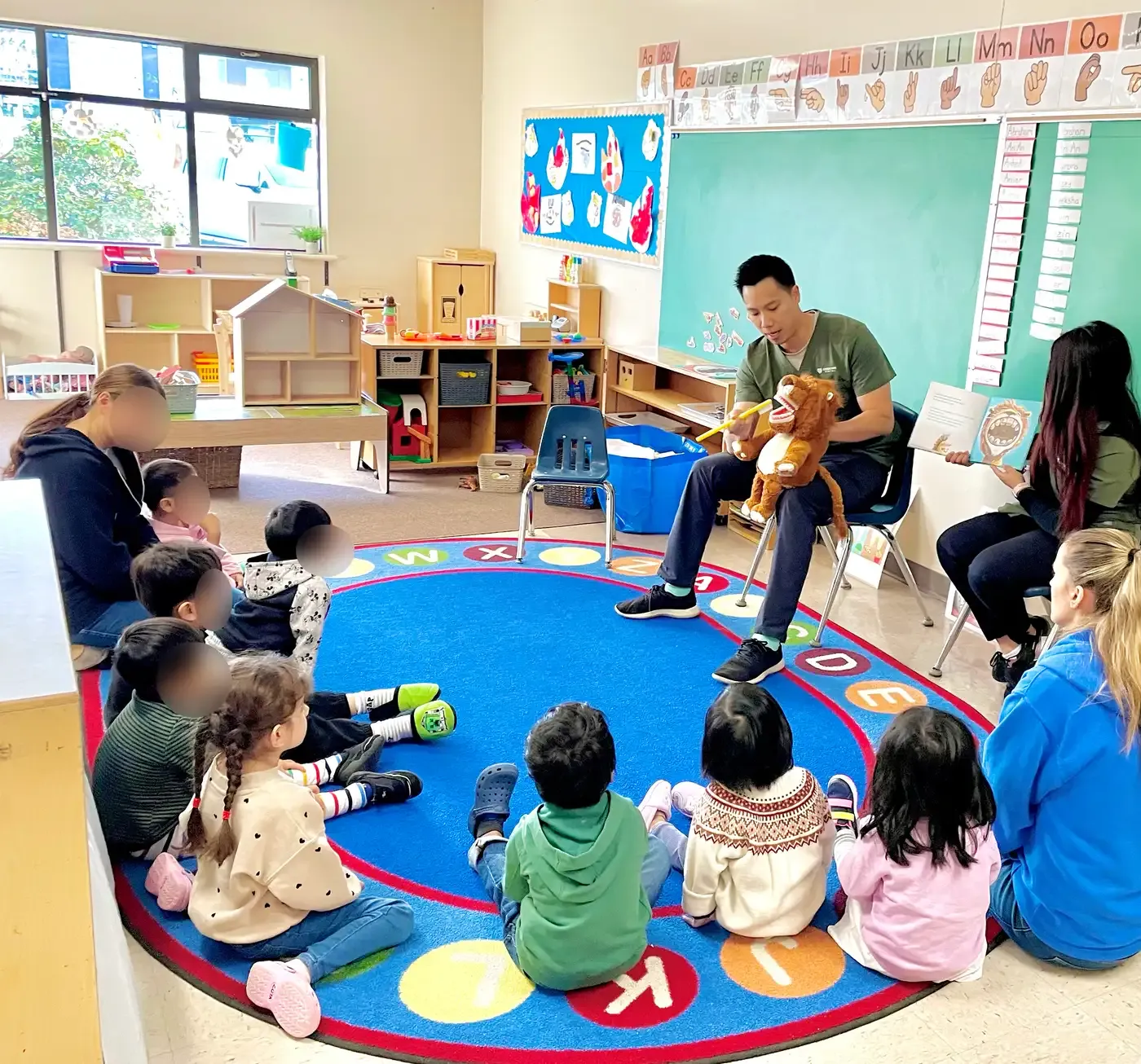 Dr. Brian Hu teaching a class of young students about brushing teeth at a local Willoughby school